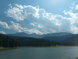 Large body of water surrounded by lush green grass and trees — sample image to sharpen