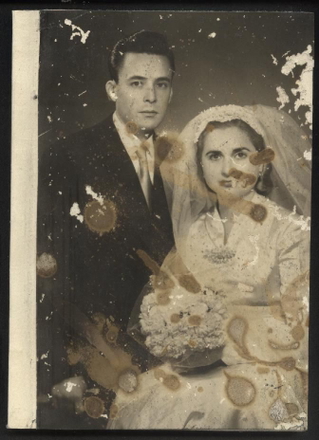 Water-damaged photo before AI restoration
