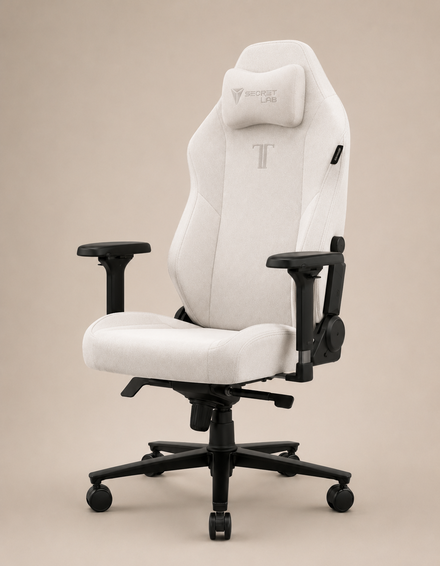 A white gaming chair with a high backrest and armrests, upholstered in soft fabric, on a beige background, shown at a front three-quarter angle.