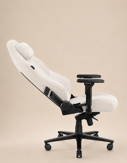 White ergonomic office chair with a curved backrest and armrests, reclined, in soft white fabric on a beige background.