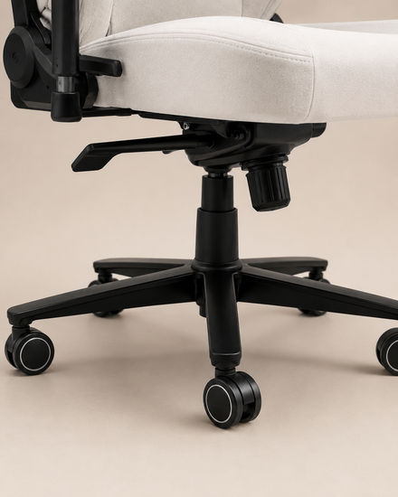 A close-up of an office chair's wheel base, showing black wheels on a white chair with a beige background.