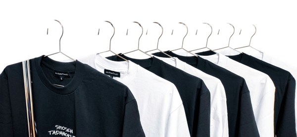A rail of black and white t-shirts on wire hangers — background removed by GoStudio.ai (Free)