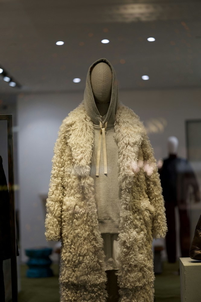 A cream shearling coat on a headless mannequin