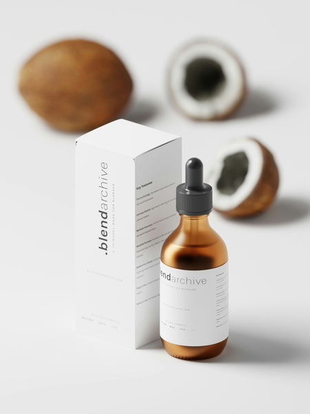 A serum bottle and its box beside a coconut