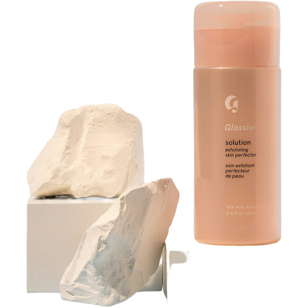 A pink cosmetic bottle balanced on a stone plinth — background removed by iLoveIMG