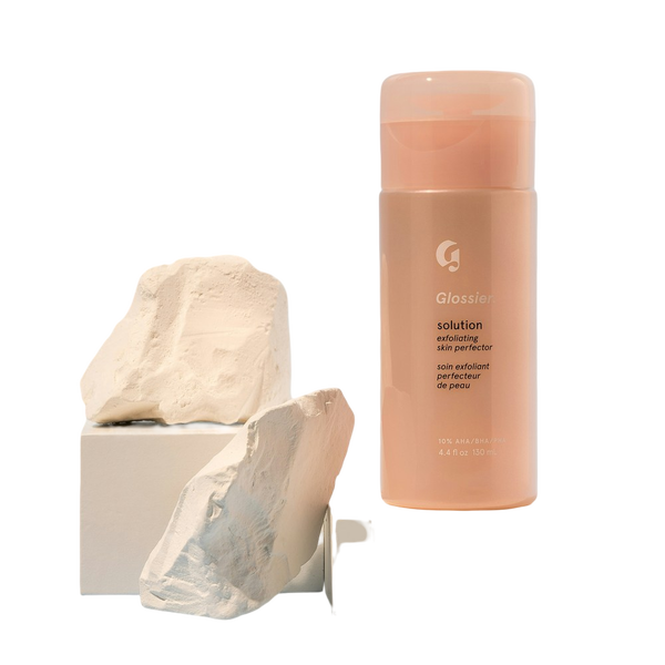 A pink cosmetic bottle balanced on a stone plinth — background removed by GoStudio.ai (Free)