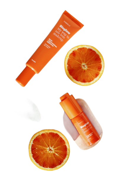 Orange skincare tubes scattered with blood orange slices — background removed by Erase.bg