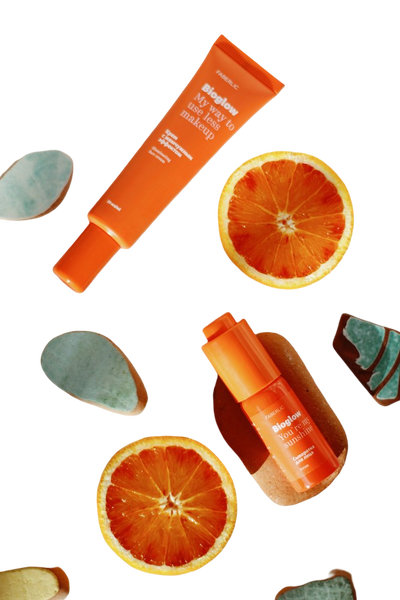 Orange skincare tubes scattered with blood orange slices — background removed by GoStudio.ai (Free)