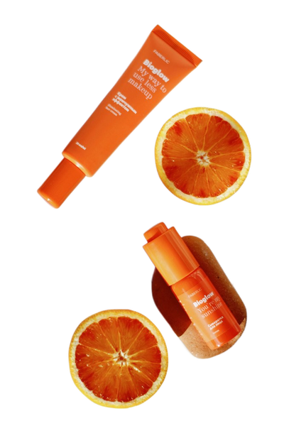 Orange skincare tubes scattered with blood orange slices — background removed by Remove.bg