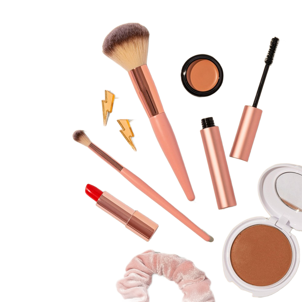 Make-up brushes, lipsticks and compacts on a beige background — background removed by Erase.bg