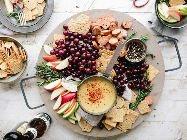 A grazing board of fruit, crackers and dips