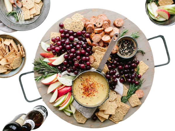 A grazing board of fruit, crackers and dips — background removed by Photoroom