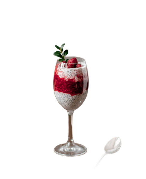 A berry parfait in a tall glass beside a spoon — background removed by Erase.bg