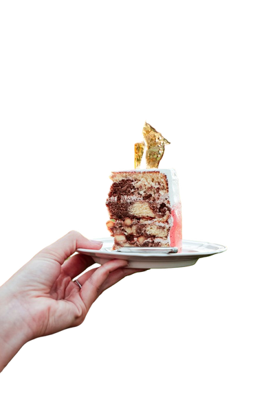 A hand holding a small cake on a plate — background removed by GoStudio.ai (Free)