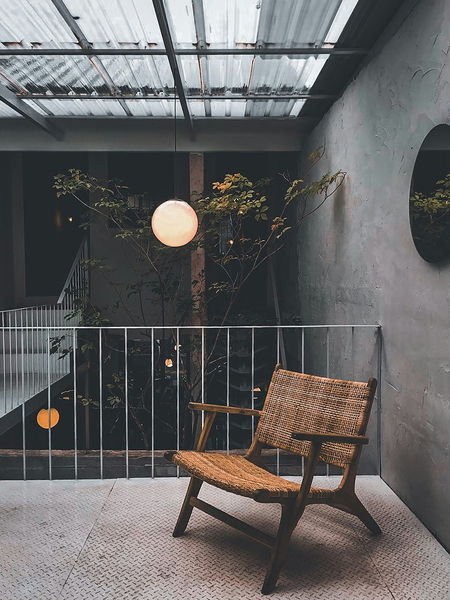 A wooden lounge chair on a balcony