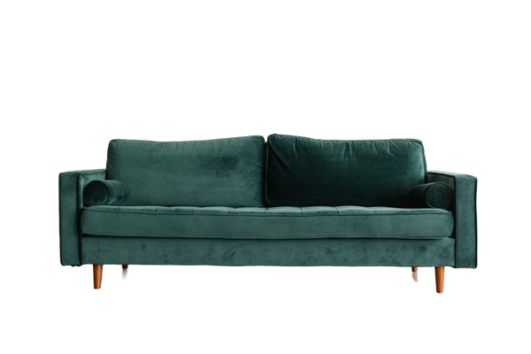 A green velvet sofa on a wooden floor — background removed by Erase.bg