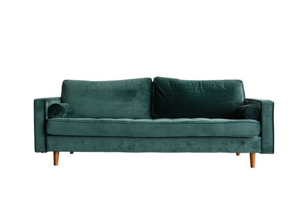 A green velvet sofa on a wooden floor — background removed by Remove.bg