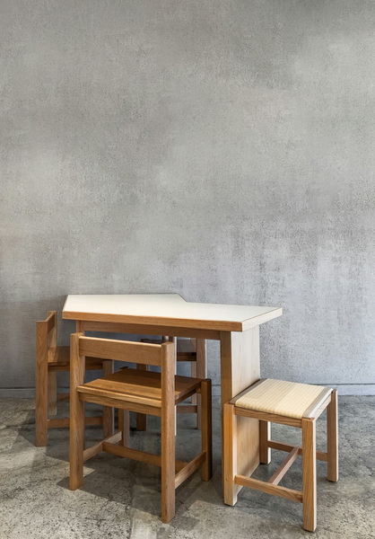 A wooden table with two nested stools