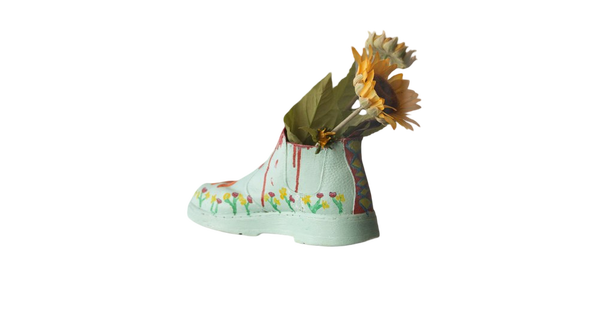 Sunflowers arranged in a pale green boot-shaped vase — background removed by GoStudio.ai (Free)