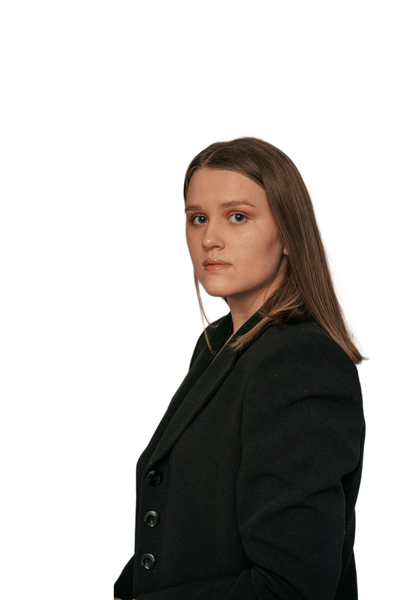 A woman in a dark blazer in front of dried pampas grass — background removed by Photoroom
