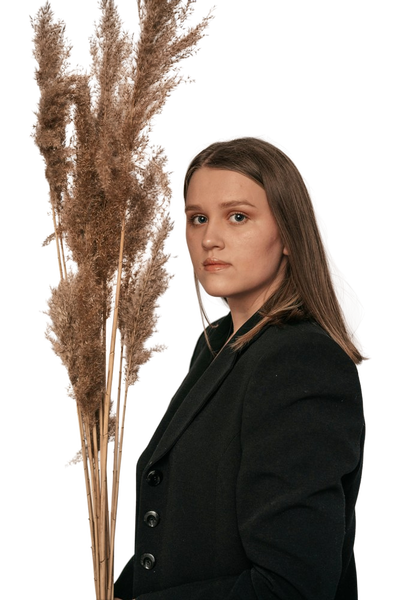 A woman in a dark blazer in front of dried pampas grass — background removed by Remove.bg