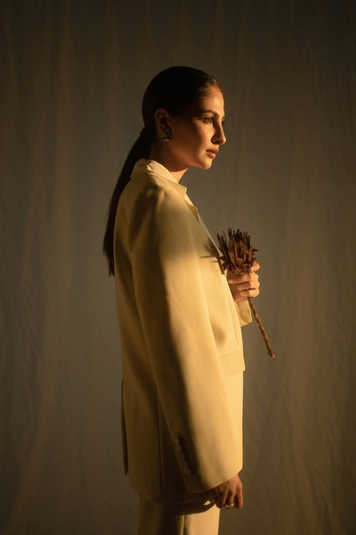 A woman in a yellow coat photographed in low light