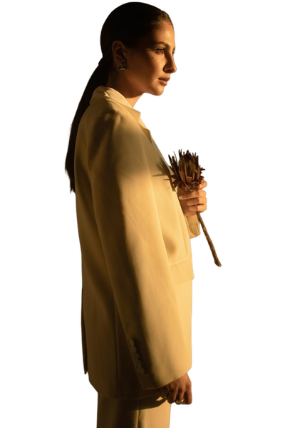 A woman in a yellow coat photographed in low light — background removed by iLoveIMG