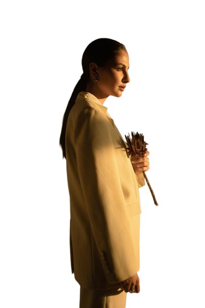 A woman in a yellow coat photographed in low light — background removed by Photoroom
