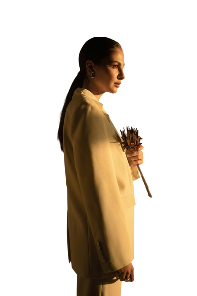 A woman in a yellow coat photographed in low light — background removed by Remove.bg
