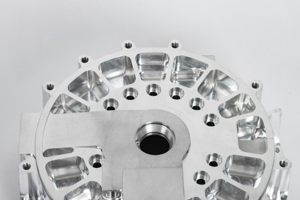 A machined aluminium housing with bolt holes