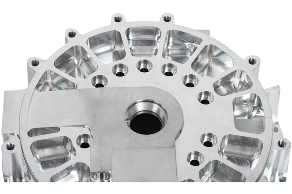 A machined aluminium housing with bolt holes — background removed by iLoveIMG