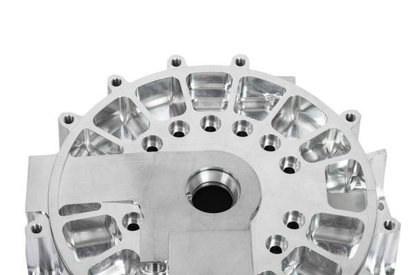 A machined aluminium housing with bolt holes — background removed by GoStudio.ai (Free)