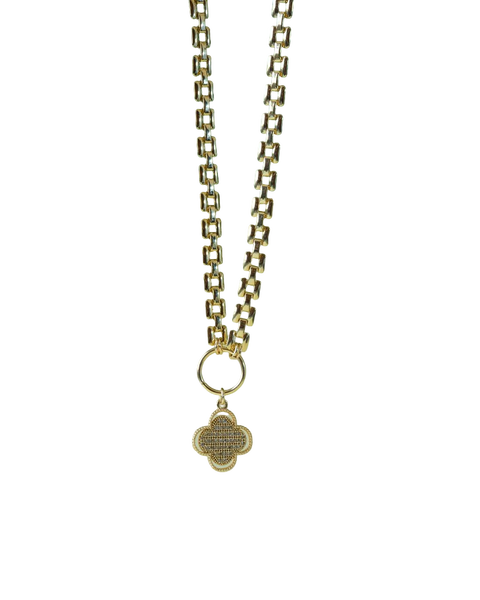 A gold chain necklace with a pendant, lying on a green leaf — background removed by GoStudio.ai (Free)