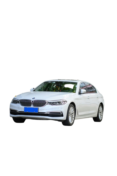 A white saloon car parked on a tree-lined street — background removed by Remove.bg