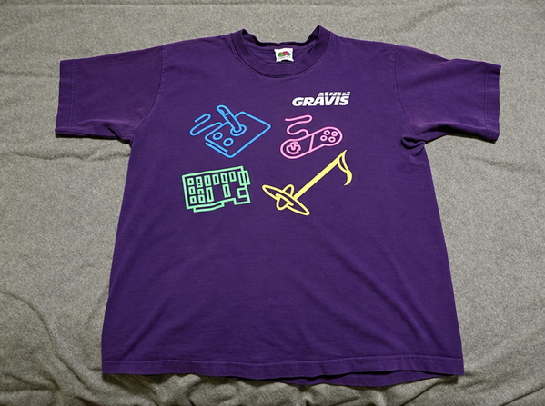 Purple T-shirt with a neon musical-instrument print, laid flat on a sheet — upscaled by GPT Image 2.5