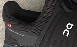 Close-up of a black mesh running shoe