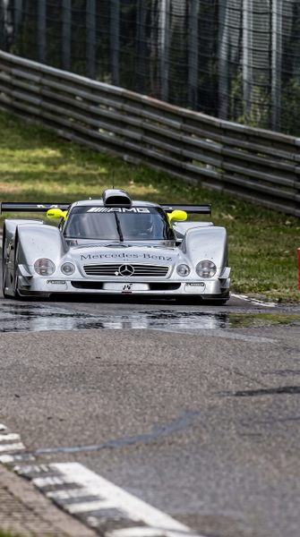 White racing prototype on a circuit, from a low angle — upscaled by GoStudio Advanced
