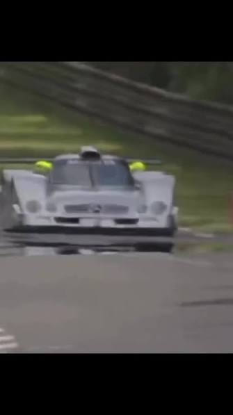 White racing prototype on a circuit, from a low angle