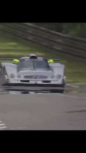 White racing prototype on a circuit, from a low angle — upscaled by GoStudio Lite