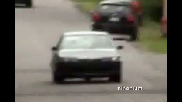 White hatchback on a suburban road, from a 1280×720 video still — upscaled by GoStudio Lite