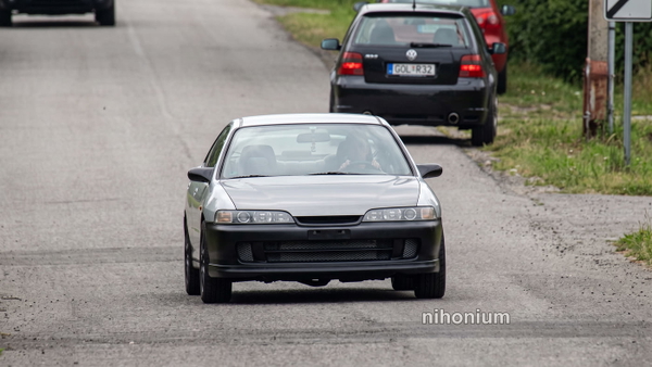 White hatchback on a suburban road, from a 1280×720 video still — upscaled by Nano Banana 2