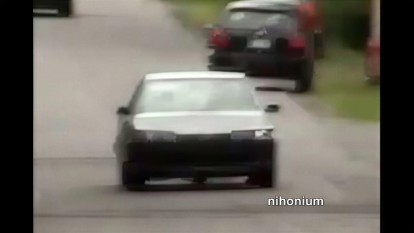 White hatchback on a suburban road, from a 1280×720 video still — upscaled by GoStudio Pro