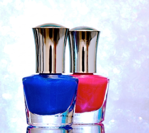 Two nail-polish bottles, blue and pink, with silver caps against a sparkling background — upscaled by Nano Banana 2