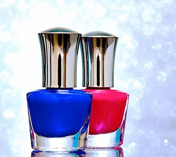 Two nail-polish bottles, blue and pink, with silver caps against a sparkling background — upscaled by GPT Image 2.5