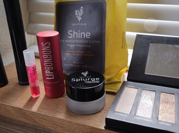 Make-up products on a shelf, including a packaged product with small printed text — upscaled by GoStudio Advanced