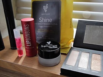 Make-up products on a shelf, including a packaged product with small printed text