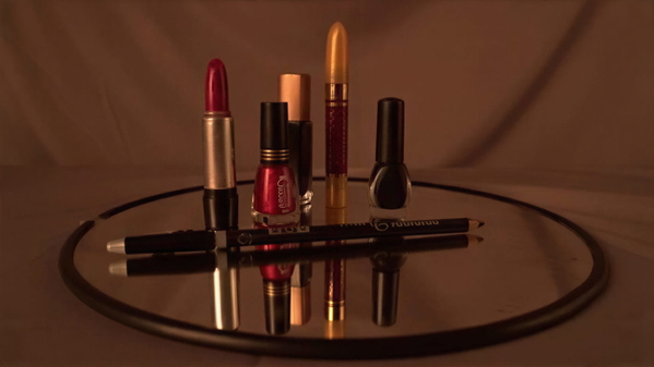 Lipsticks and nail polish arranged on a round mirrored tray — upscaled by GoStudio Lite