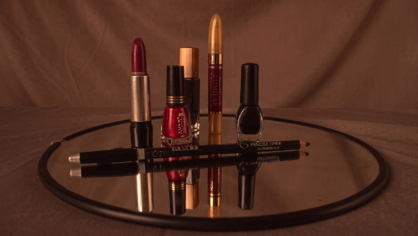 Lipsticks and nail polish arranged on a round mirrored tray — upscaled by Nano Banana 2