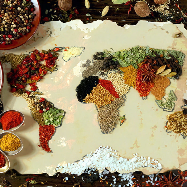 World map laid out in coloured spices and grains on a pale surface — upscaled by GoStudio Pro