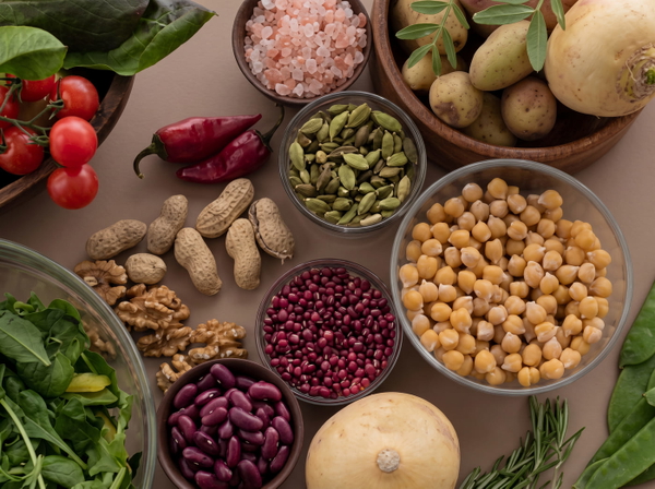 Overhead spread of pulses, nuts and vegetables in small bowls — upscaled by GoStudio Advanced